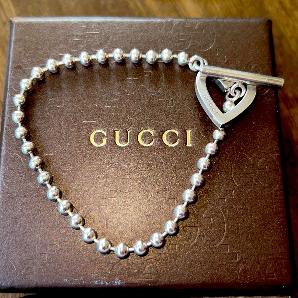 Gucci Sterling Silver bracelet.   7 in.   Silver balls connecting to the heart